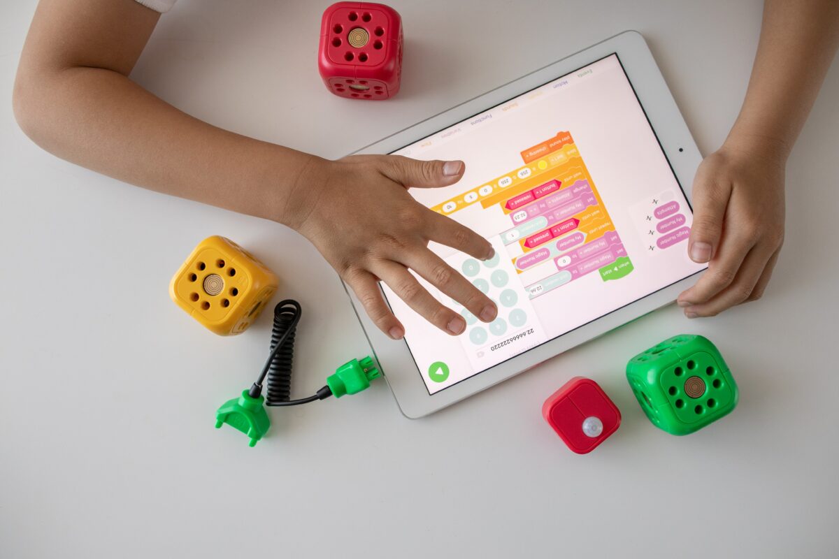 An ipad being used by a child that has a coding app on it.