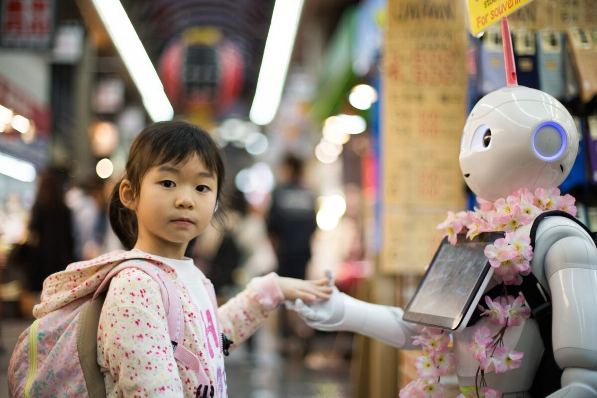 A little girl interacting with a robot