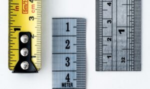 Three different rulers and/or measuring tapes